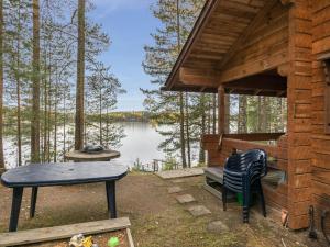 a cabin with a table and a table and a bench at Holiday Home Päivärinne by Interhome in Vuoriniemi