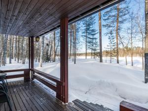 a screened porch with a view of the snow at Holiday Home 2234 by Interhome in Savonranta