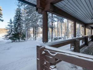 a porch of a cabin in the snow at Holiday Home Villa kontio by Interhome in Savonranta +22 photos