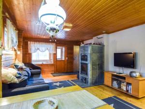 a living room with a couch and a tv at Holiday Home Mykkylä by Interhome in Niemi +13 photos