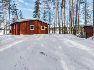a house in the snow with a dirt road at Holiday Home 2233 by Interhome in Savonranta