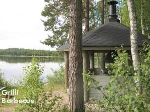 a gazebo sitting next to a lake at Holiday Home Varvali by Interhome in Lahdenkylä