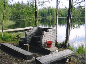 a block retaining wall next to a lake at Holiday Home Aittolahti 1 by Interhome in Hopsu