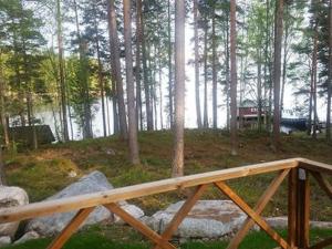 a wooden bridge in the middle of a forest at Holiday Home Ylä-hannala by Interhome in Muurame