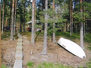 a boat laying on the ground in the woods at Holiday Home Aittolahti 1 by Interhome in Hopsu +19 photos