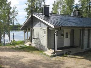a small house next to a body of water at Holiday Home Varvali by Interhome in Lahdenkylä