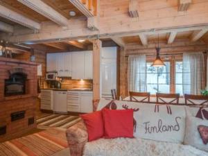 a living room with a couch and a kitchen at Holiday Home Ahonranta by Interhome in Juntusranta