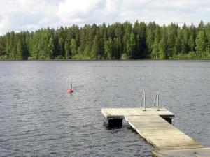 a dock in the middle of a large lake at Holiday Home Harjunniemi by Interhome in Vilppula