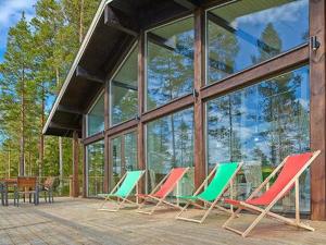 a group of chairs sitting in front of a building at Holiday Home Villa miestamo by Interhome in Ruovesi