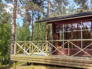 a wooden cabin in the middle of a forest at Holiday Home Ylähuone by Interhome in Pätiälä