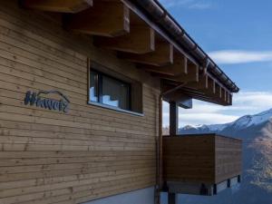 a building with a sign on the side of it at Apartment Huwetz 3 1-2 Zimmerwohnung by Interhome in Bettmeralp