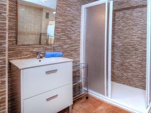 a bathroom with a white sink and a shower at Apartment Vermell-8 by Interhome in Platja  d'Aro +4 photos