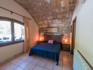 a bedroom with a bed and a stone wall at Villa Les Mines by Interhome in Selva +28 photos