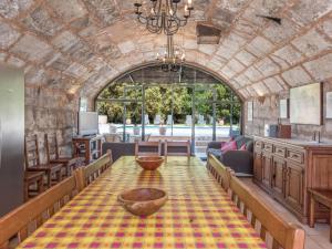 a dining room with a table and a large window at Villa Les Mines by Interhome in Selva