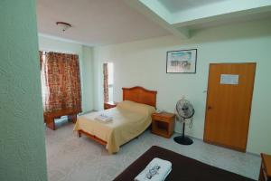 Postel nebo postele na pokoji v ubytování HOTEL EL CONQUISTADOR MONARCA.
