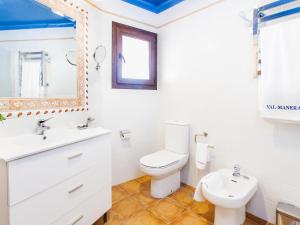 a bathroom with a toilet and a sink and a mirror at Villa Zurbarán by Interhome in Rincón de la Victoria