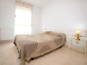 a bedroom with a bed and a window and a table at Apartment La Ermita-1 by Interhome in Calpe