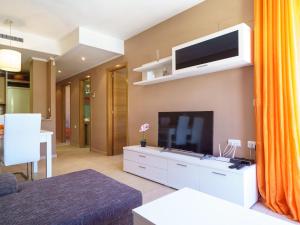 Una sala de estar con un televisor de pantalla plana en una pared. en Apartment Sueno del Mar by Interhome, en Moraira