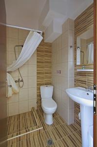 łazienka z toaletą i umywalką w obiekcie Hotel Paris w Paralii Katerinis +37 zdjęć