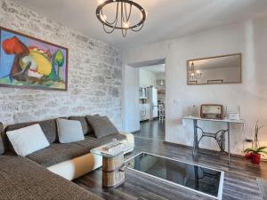 a living room with a couch and a table at Holiday Home Stefanina by Interhome in Labin