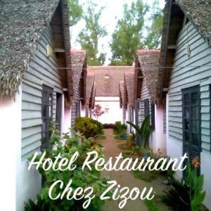 a resort with a hotel restaurant chef asylum sign next to a building at Chez Zizou Manakara in Manakara
