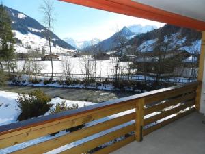 a balcony with a view of a snow covered mountain at Apartment La Sarine 212 by Interhome in Gstaad