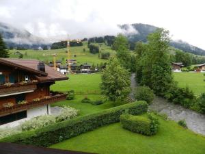a river in a field next to a house at Apartment La Sarine 324 by Interhome in Gstaad