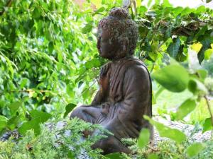 a statue of a woman sitting in the bushes at Apartment Christeli by Interhome in Zweisimmen