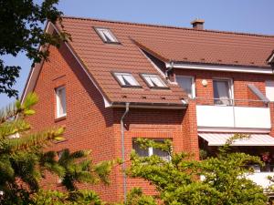 a red brick house with windows and a roof at Haus Nordstrand Berliner Strasse 1a in Büsum
