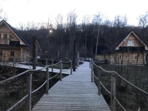 a wooden boardwalk leading down to a house at Walden Cabin in Steninge