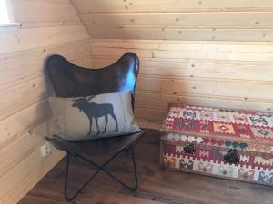 a chair with a pillow on it next to a box at Walden Cabin in Steninge