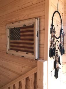 una bandera americana al lado de una cabaña con ventana en Walden Cabin en Steninge