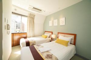 Postel nebo postele na pokoji v ubytování Tabata Oji Hotel + 37 fotografií