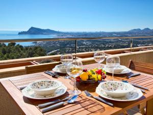 a table with wine glasses and a bowl of fruit at Apartment Villa Marina Golf-1 by Interhome in Altea la Vieja