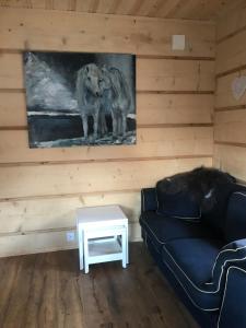 a living room with a couch and a table at Fjäll Stuga in Steninge