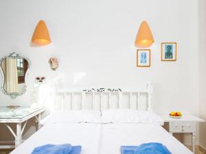 a white bedroom with a white bed and a mirror at Holiday Home Las Boyas by Interhome in Moraira