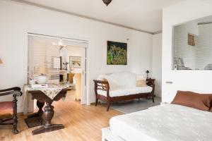 a bedroom with a bed and a desk and a chair at Classy lux apt w/ sea view, garden, parking in Corfu