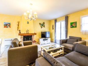 a living room with two couches and a tv at Holiday Home Les Grillons by Interhome in Saint-Palais-sur-Mer