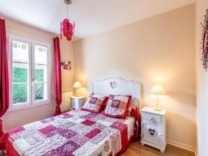 a bedroom with a bed and two tables and two lamps at Holiday Home Les Grillons by Interhome in Saint-Palais-sur-Mer
