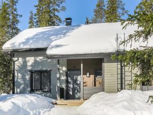 a house with snow on the roof at Holiday Home Aihki a by Interhome in Syöte