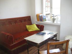 a living room with a couch and a table with a laptop at Apartment Villa Alpenblick Wolfenschiessen by Interhome in Wolfenschiessen