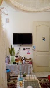 ein Wohnzimmer mit einem Flachbild-TV an der Wand in der Unterkunft Pulisen Homestay in Puli