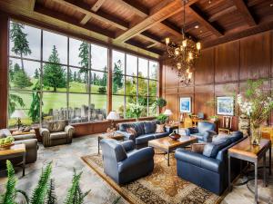 a living room filled with furniture and a large window at Olympic Lodge by Ayres in Port Angeles