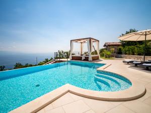 a swimming pool in a villa with a view at Villa Marone by Interhome in Dobreć