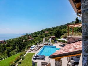 a villa with a swimming pool and the ocean at Villa Marone by Interhome in Dobreć +59 photos