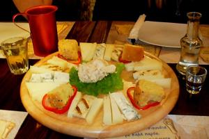 a plate of food on a wooden table at 24 Seven Boutique Hotel in Malia