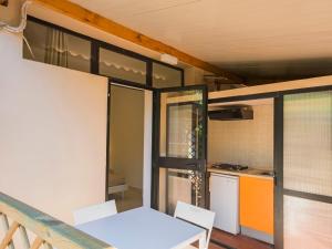 a small kitchen with a white table and chairs at Holiday Home Gineprino-7 by Interhome in Marina di Bibbona