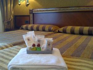 a tray of food on a bed in a hotel room at Hotel Begoña Park in Gijón