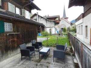 a patio with chairs and a table and a fence at Apartment Studio Oehrli by Interhome in Gstaad