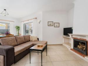 a living room with a couch and a fireplace at Holiday Home Manta Rota 450m from the Beach by Interhome in Altura